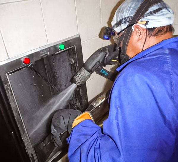 Technician repairing a rubbish chute